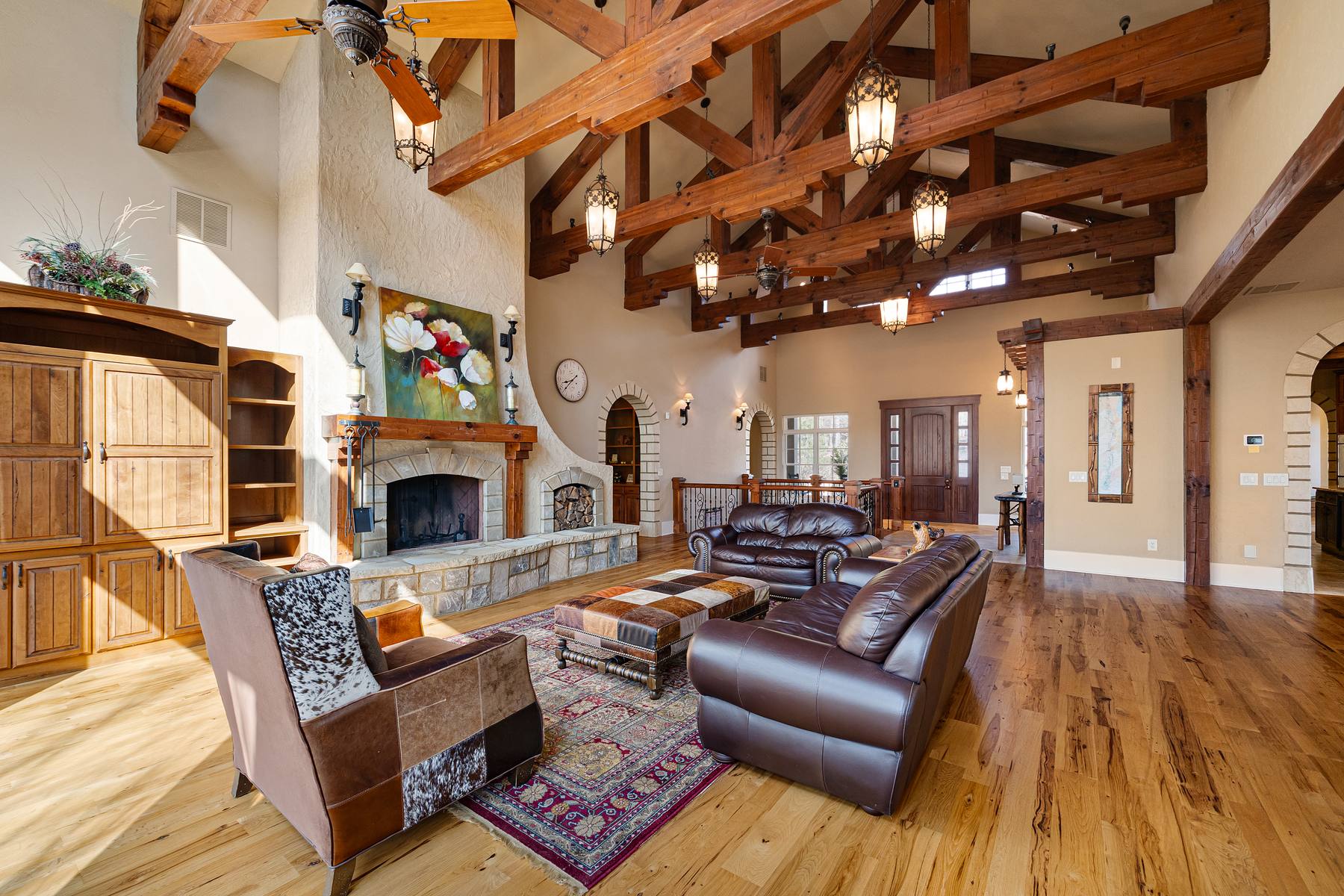 Great room with stone fireplace and hand-planed pine trusses
